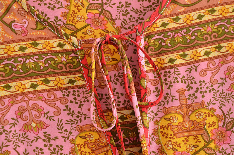 Close-up of Malbusaat spring long sleeve maxi dress with intricate floral and geometric patterns in warm colours