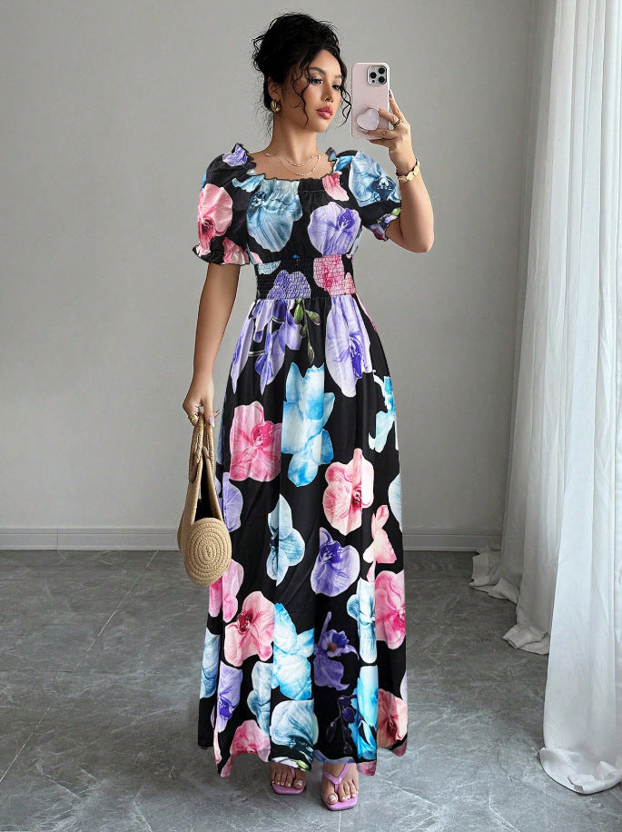 Woman wearing Malbusaat Floral Square Neck Maxi Dress with Puff Sleeves in vibrant pink and blue floral print