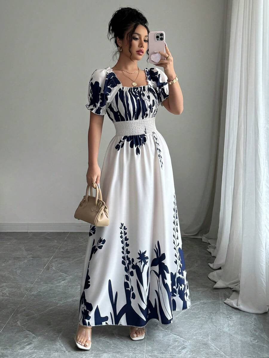 Woman wearing a Floral Square Neck Maxi Dress with Puff Sleeves in white and navy by Malbusaat