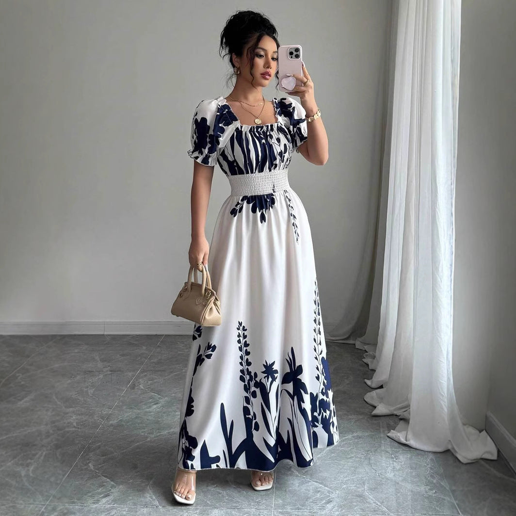 Woman wearing a Floral Square Neck Maxi Dress with Puff Sleeves in white with navy blue floral print