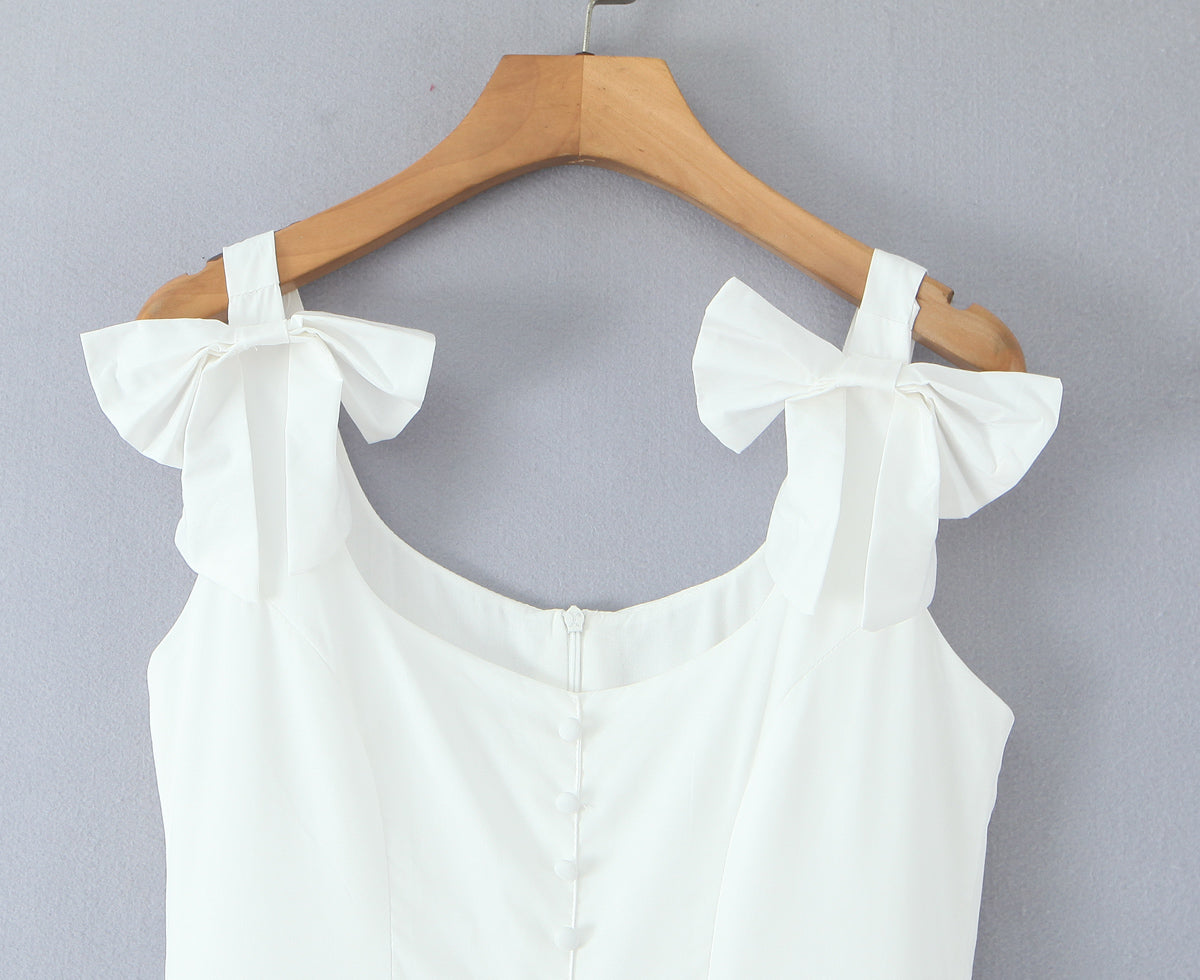 White French bowknot spaghetti dress with shoulder bow ties and fabric covered back buttons on wooden hanger