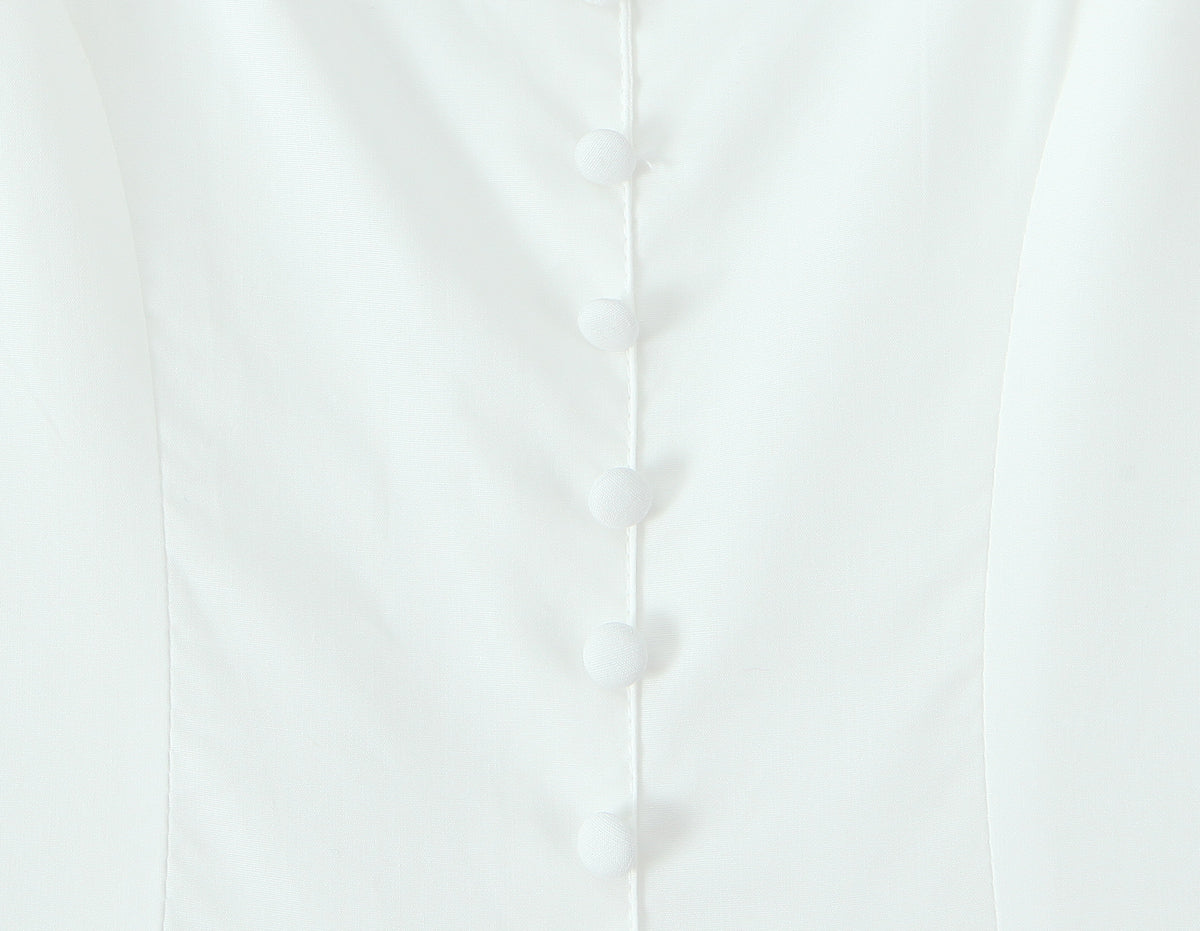 Malbusaat white French bowknot spaghetti dress close up of fitted bodice with fabric covered buttons