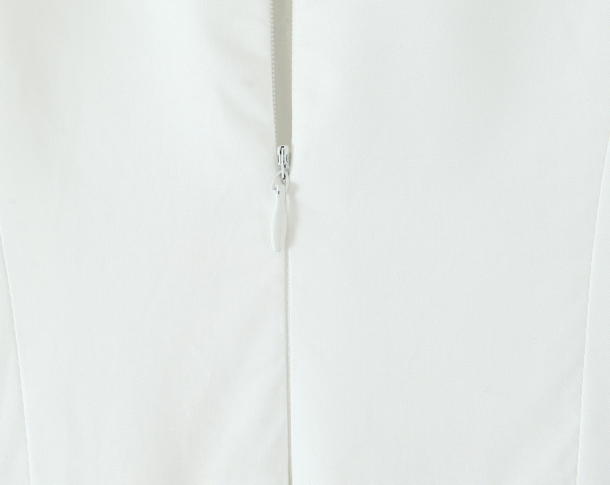 Close up back view of white French bowknot spaghetti dress showing centre silver zipper and seam details