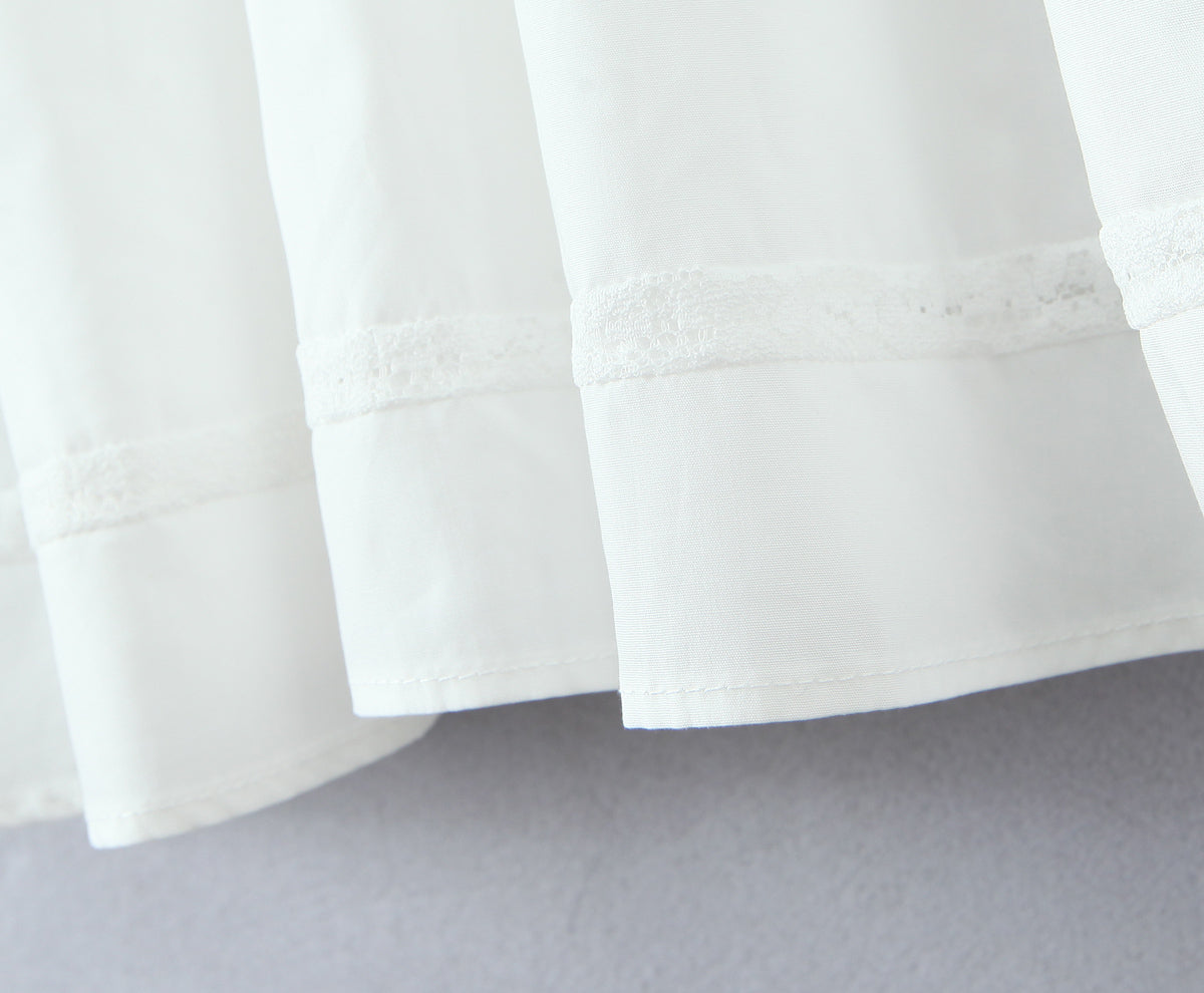 Malbusaat white French bowknot spaghetti dress close up of skirt hem with lace trim and soft layered fabric