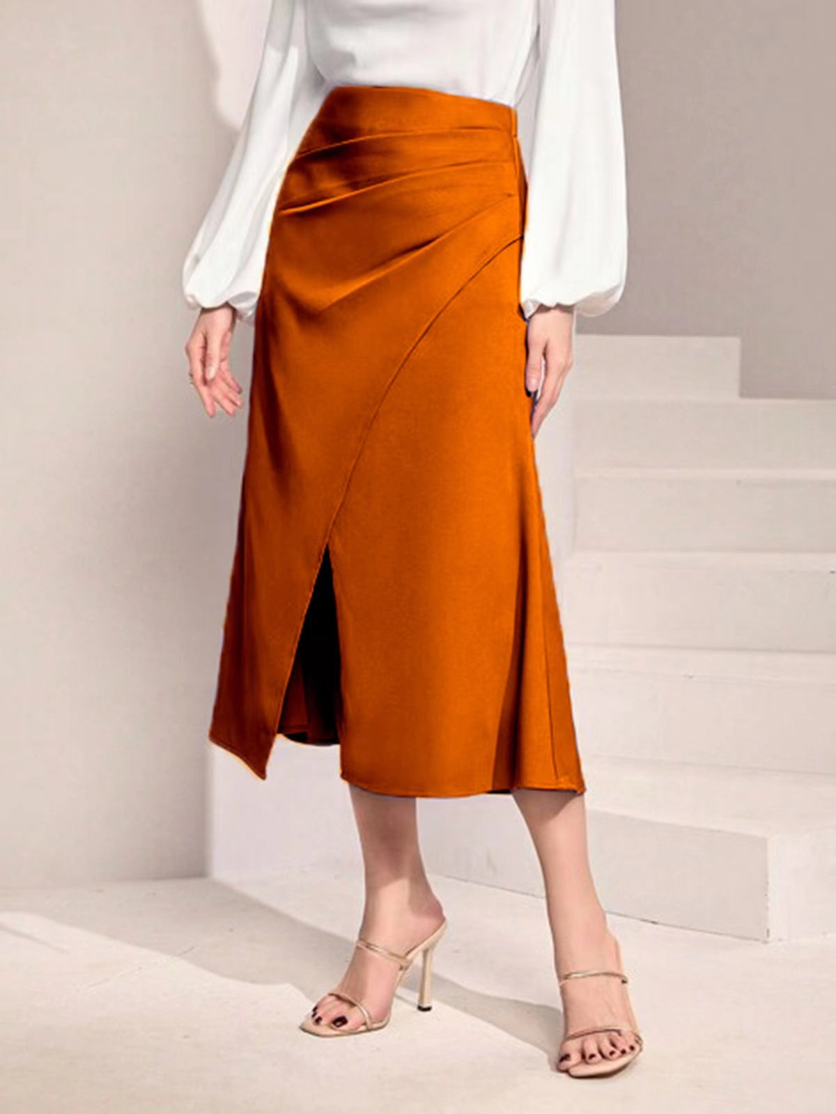 Malbusaat high waist satin skirt in burnt orange with front slit and midi length styling