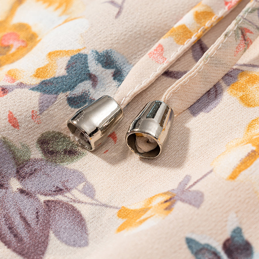 Close-up of lace up floral pullover dress detailing with metallic ends on drawstrings