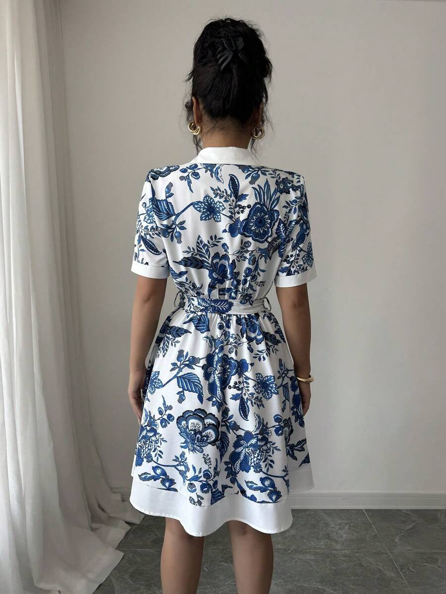 Malbusaat lace up waist midi dress in white with blue floral print and short sleeves shown from back
