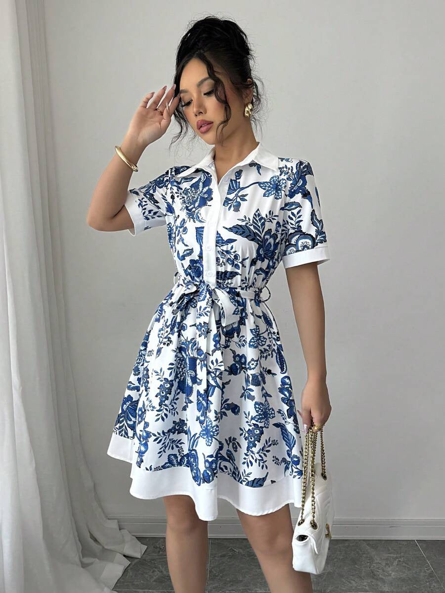 Malbusaat lace up waist midi dress with blue floral print and short sleeves on model indoors