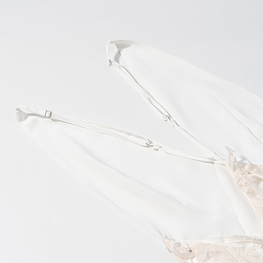 Close-up of adjustable straps on elegant lace maxi dress by Malbusaat in white