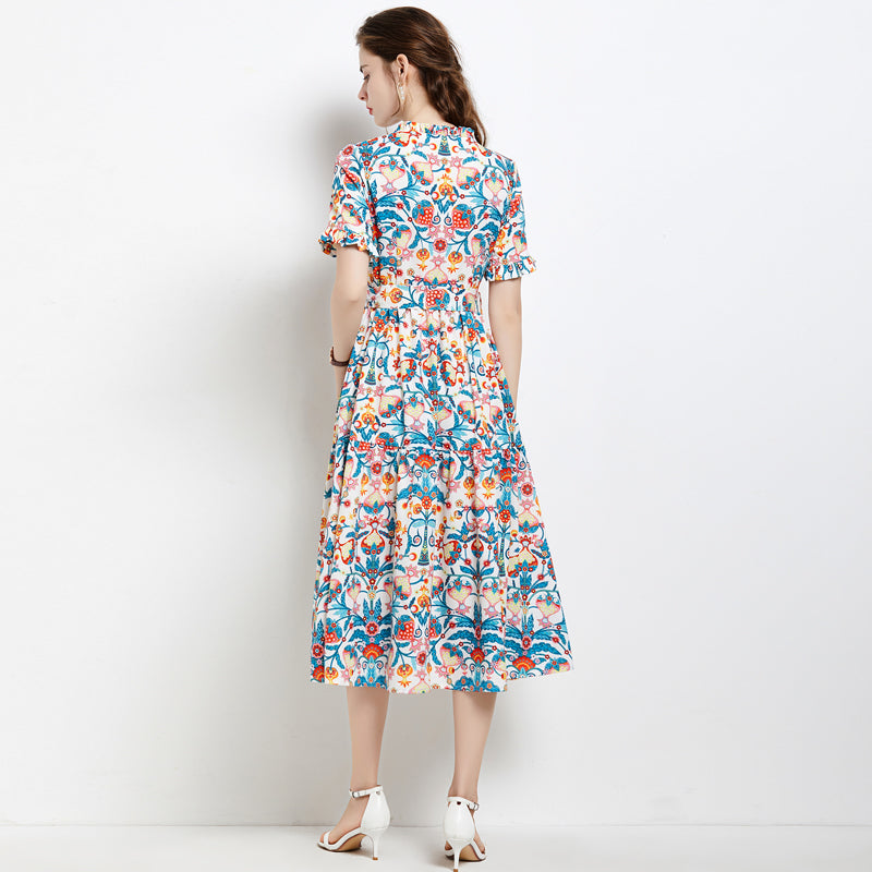 Woman wearing elegant summer maxi dress with colourful floral print and short sleeves from MEGIRL