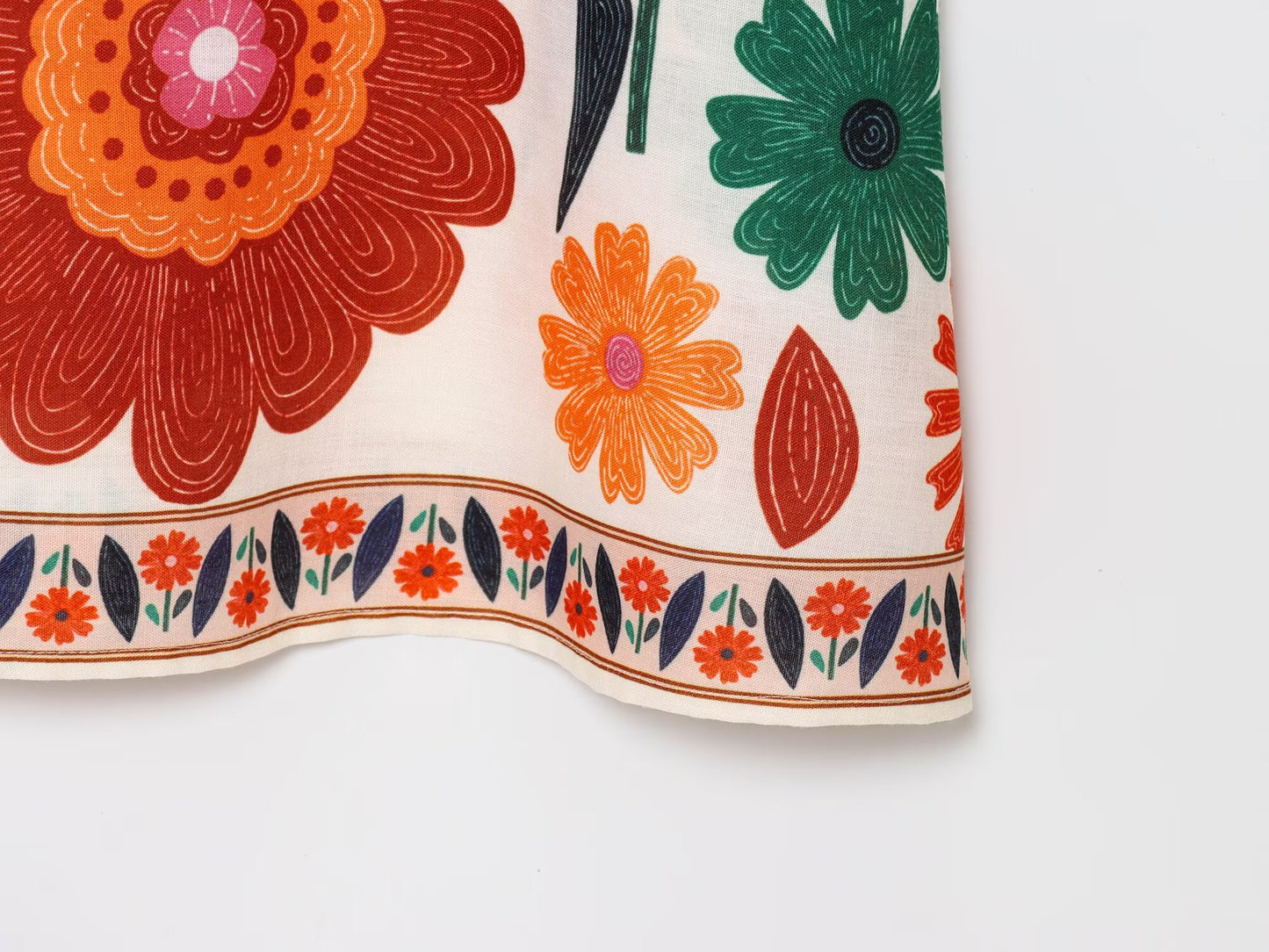 Close-up of floral pattern on Malbusaat Floral Spaghetti Strap Slim Fit Maxi dress hem
