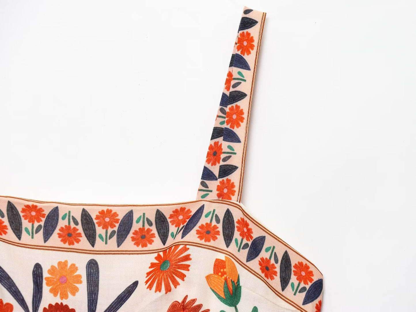 Close-up of Malbusaat Floral Spaghetti Strap Slim Fit Maxi dress featuring vibrant orange flower prints