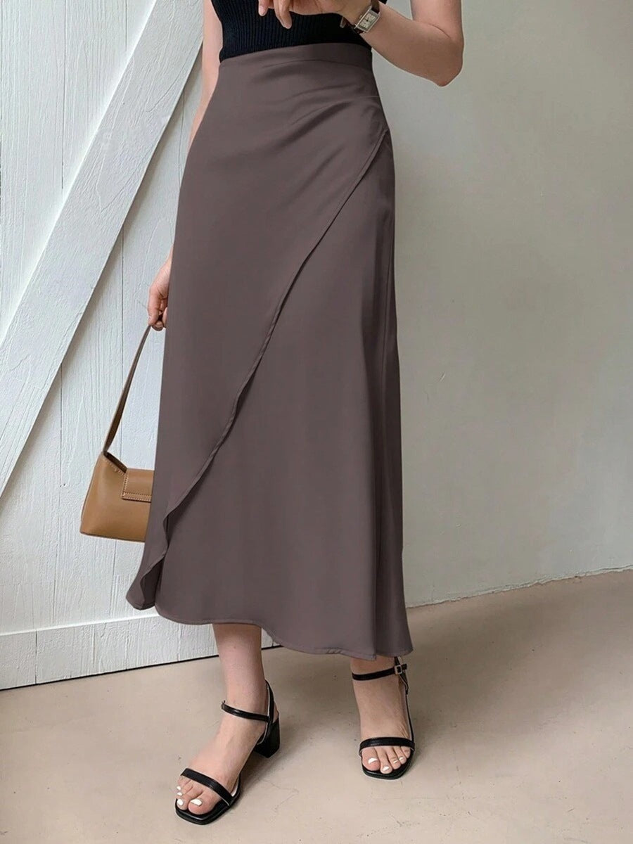 Brown satin midi skirt for women styled with black top and black strappy sandals