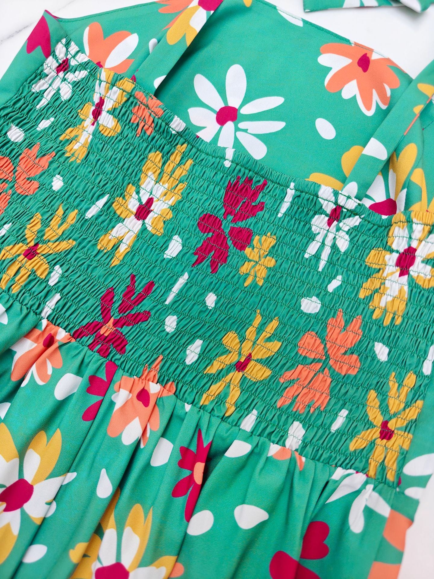 Malbusaat off shoulder floral midi dress with vibrant floral pattern and shirred bodice