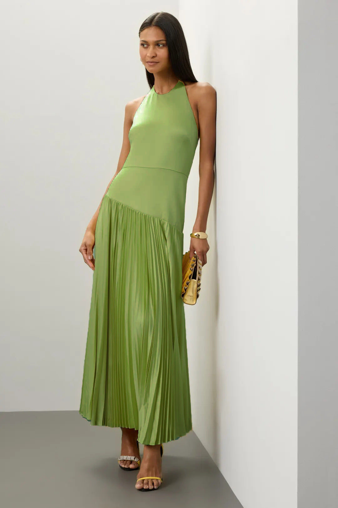 Green Pleated Halter Dress for Summer with flowing skirt and sleeveless design by Malbusaat