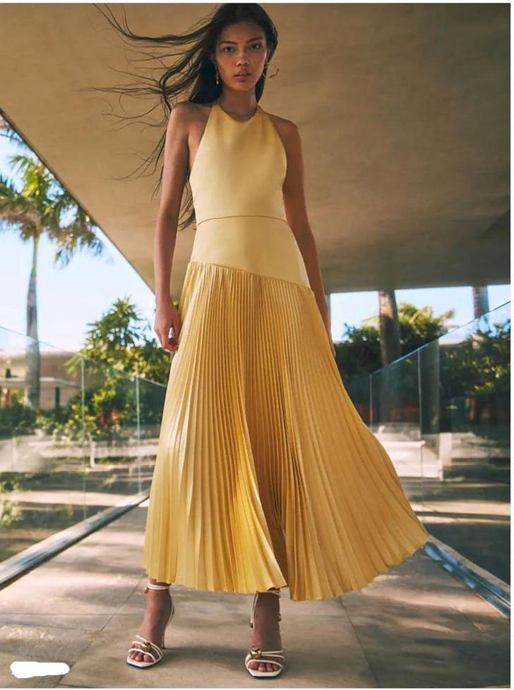 Malbusaat pleated halter dress for summer in soft yellow with flowing skirt and sleeveless design