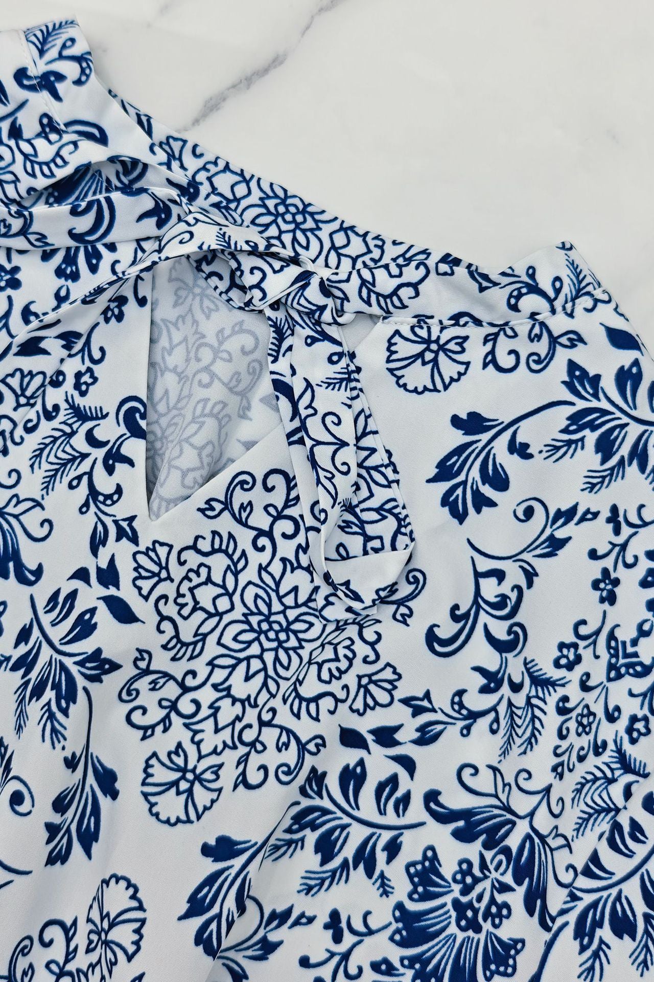 Close-up of Malbusaat printed lace up maxi dress featuring floral patterns in blue and white