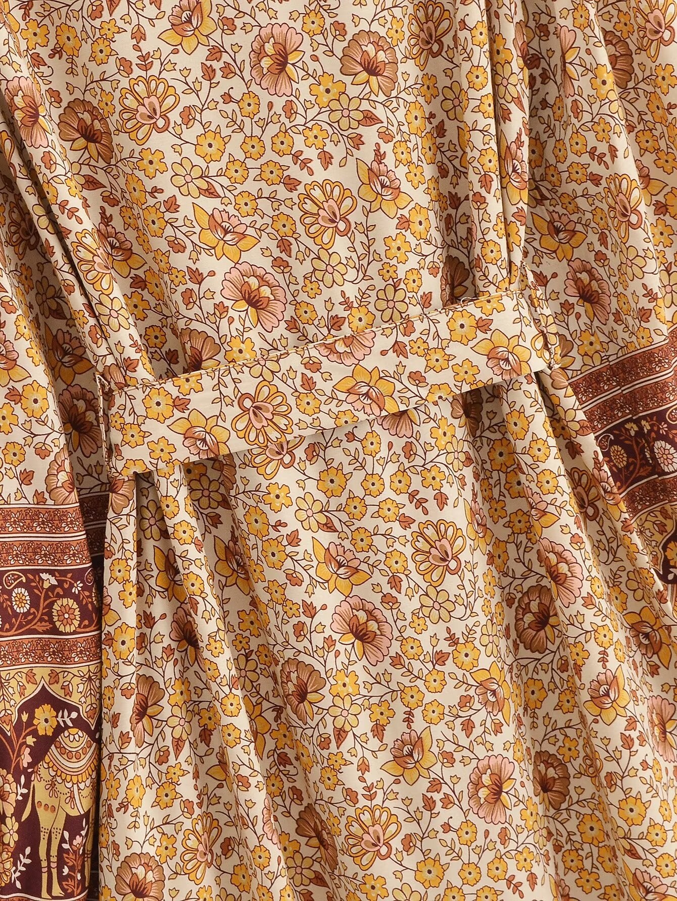 Close-up of Malbusaat printed rayon maxi dress for women with floral and elephant motifs in warm tones