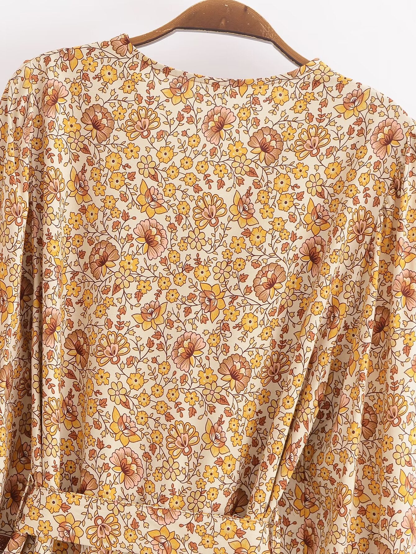 Malbusaat printed rayon maxi dress for women in beige with orange floral pattern on hanger