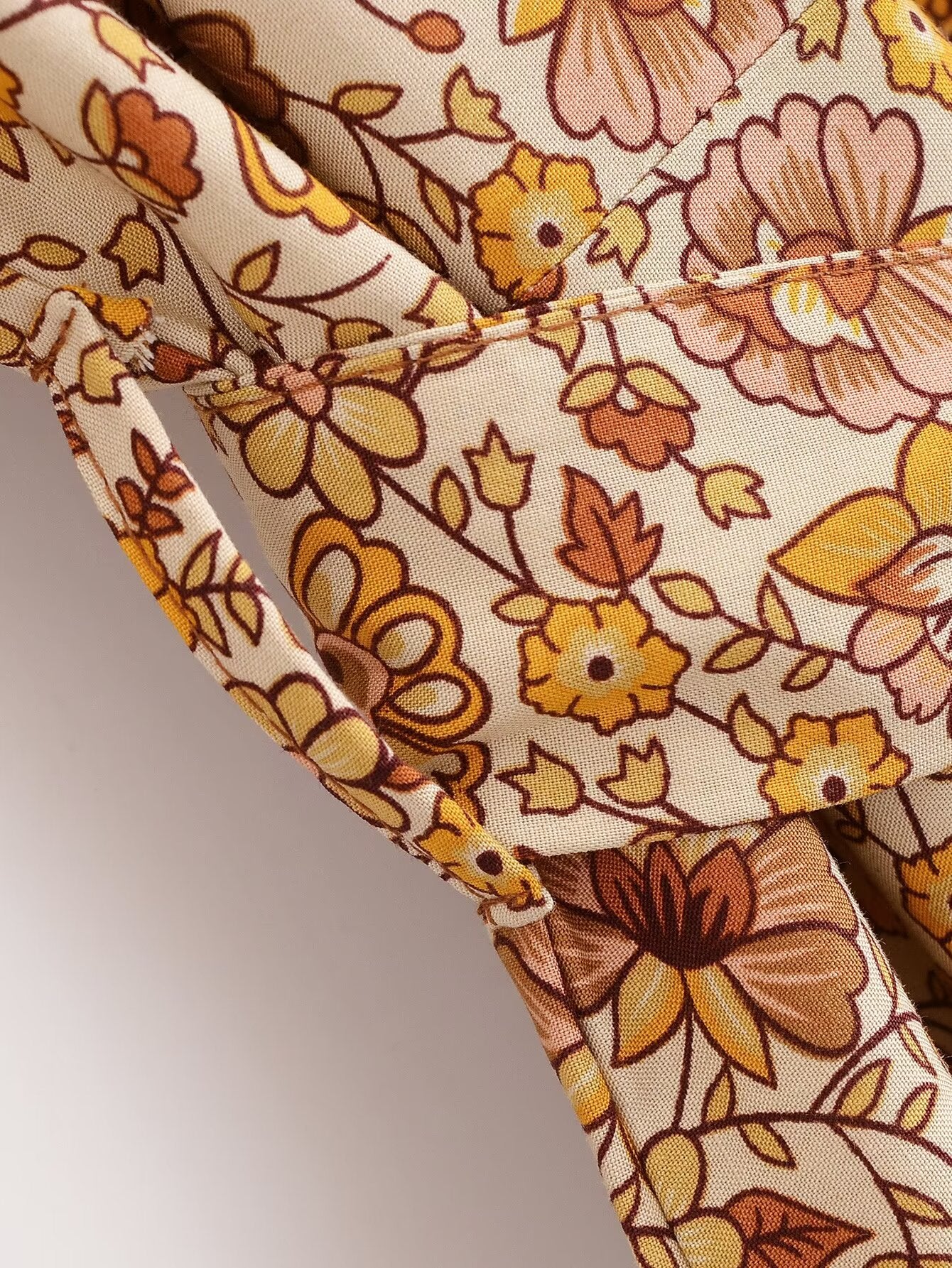 Close-up of floral pattern and stitching on printed rayon maxi dress for women by Malbusaat