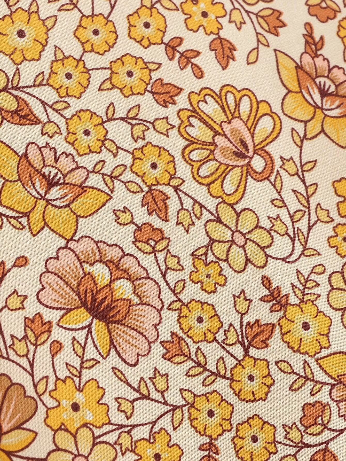 Close-up of floral pattern on printed rayon maxi dress for women by Malbusaat in yellow and brown tones
