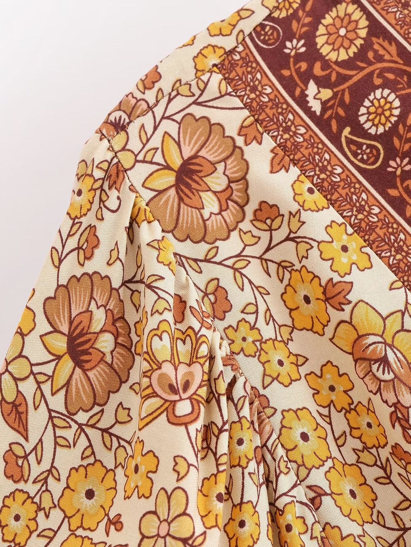Close-up of Malbusaat printed rayon maxi dress for women featuring yellow and brown floral design