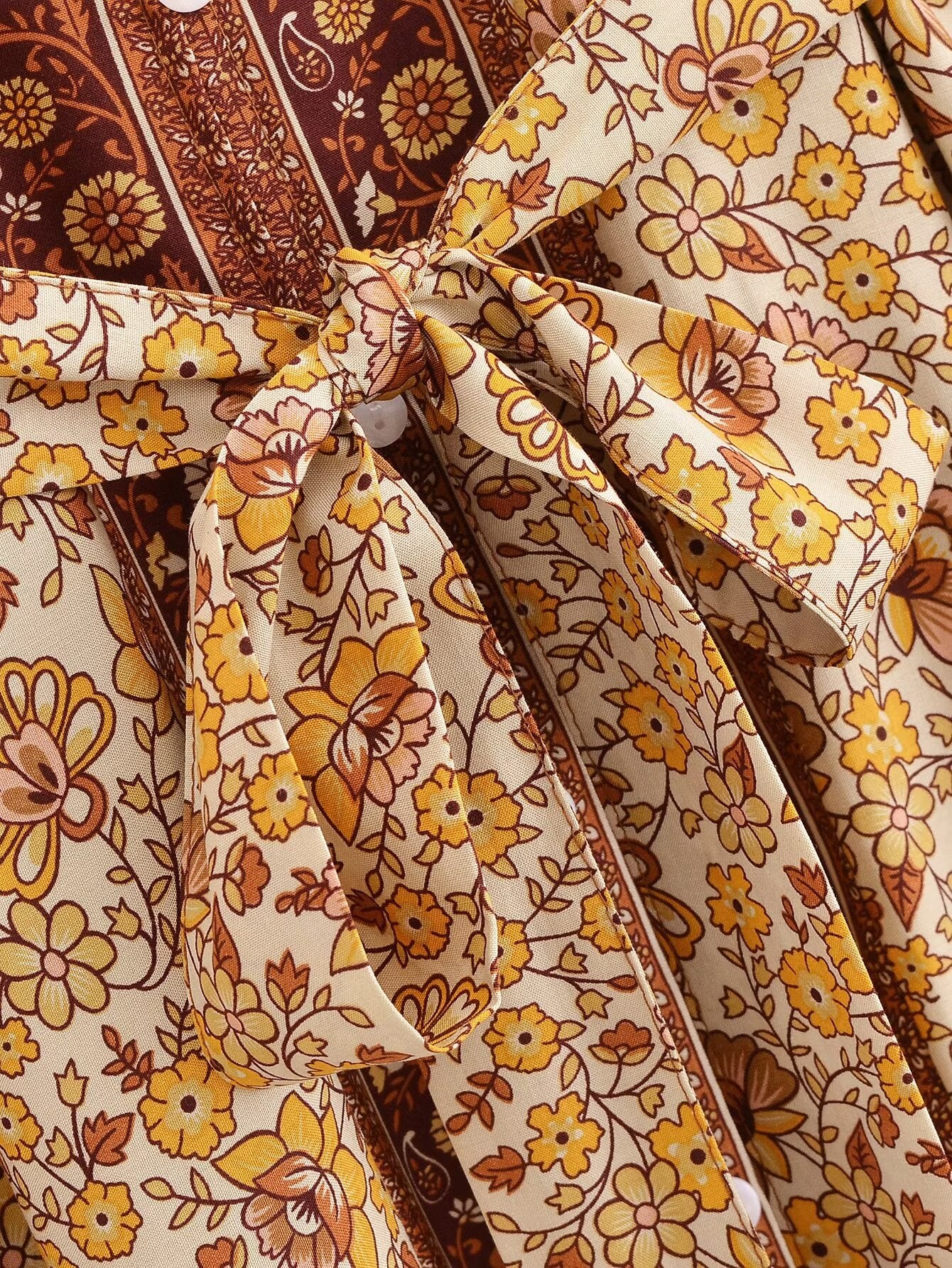 Close-up of floral tie detail on Malbusaat printed rayon maxi dress for women in yellow and brown tones