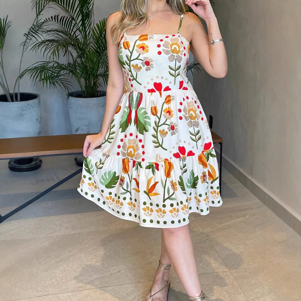 Malbusaat printed strap tiered dress with vibrant floral patterns and a flowing silhouette