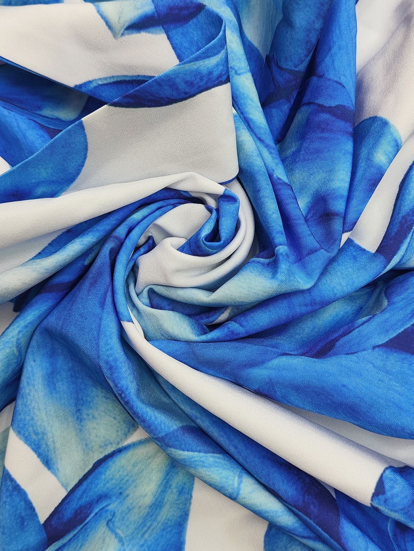 Close-up of fabric showcasing a vibrant blue pattern for a printed v neck tiered dress
