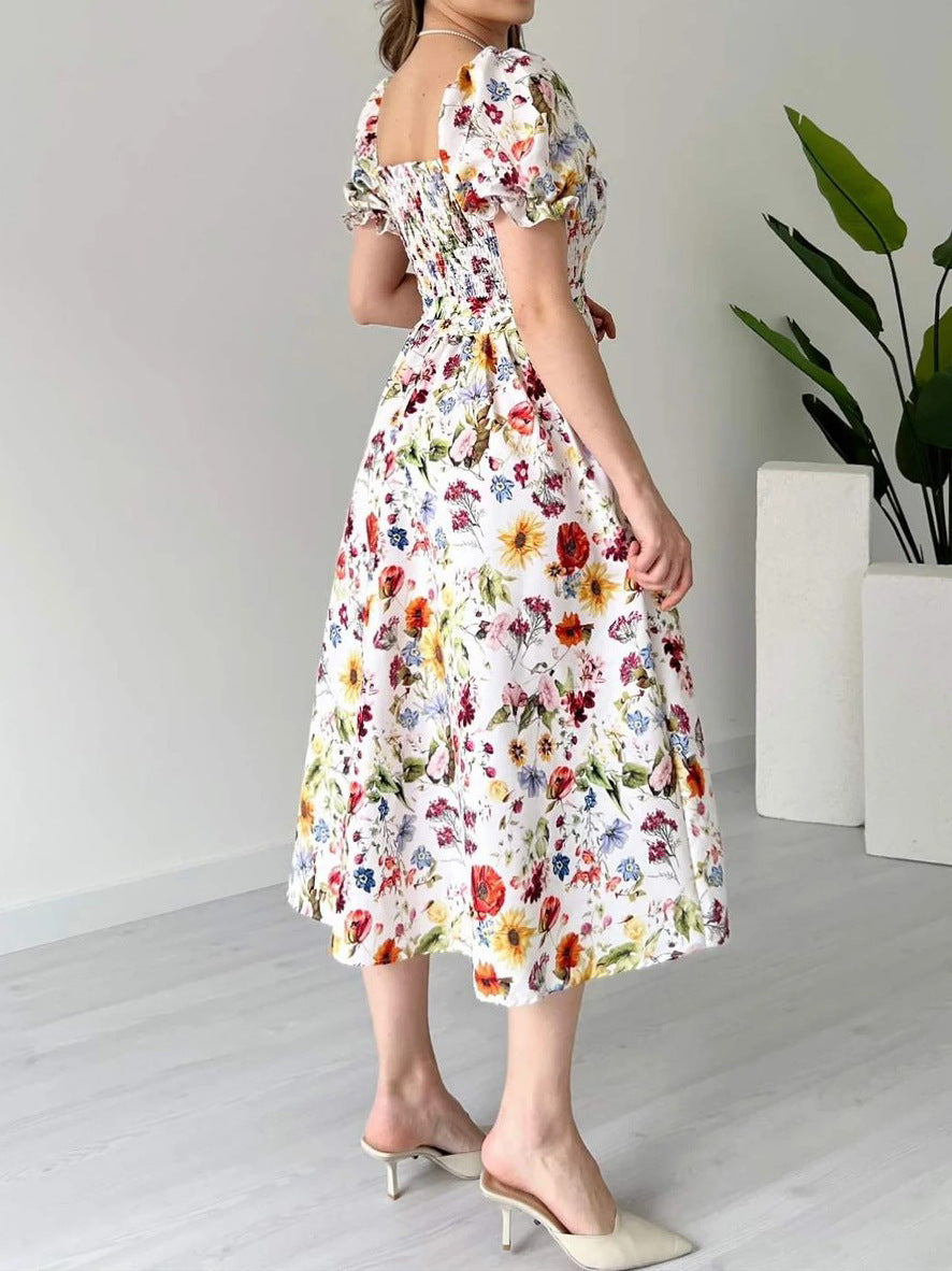 PLAYA puff sleeve floral midi dress with a fitted waist and vibrant flower patterns for a stylish summer look