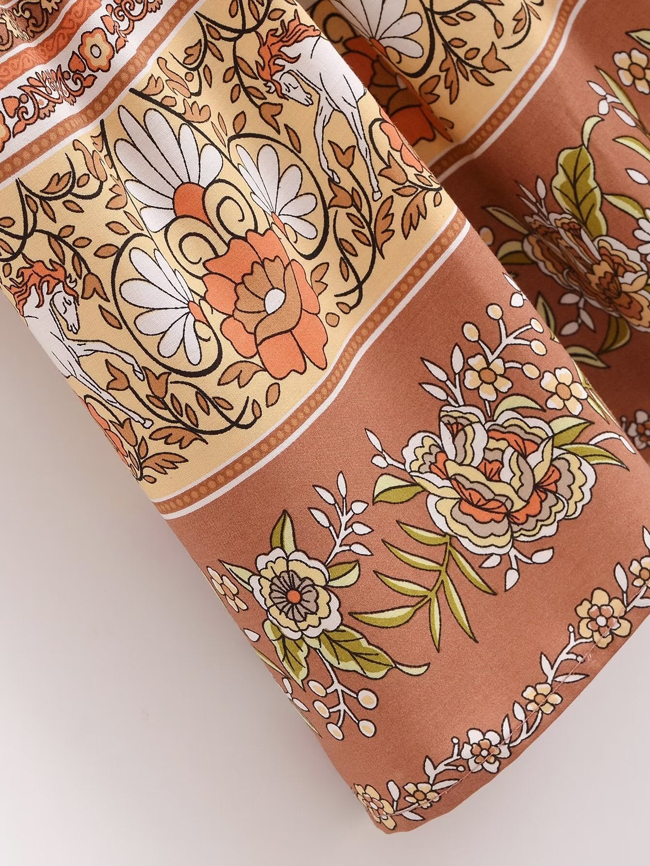 Detailed close-up of floral pattern on Malbusaat rayon printed long sleeve dress fabric in warm tones