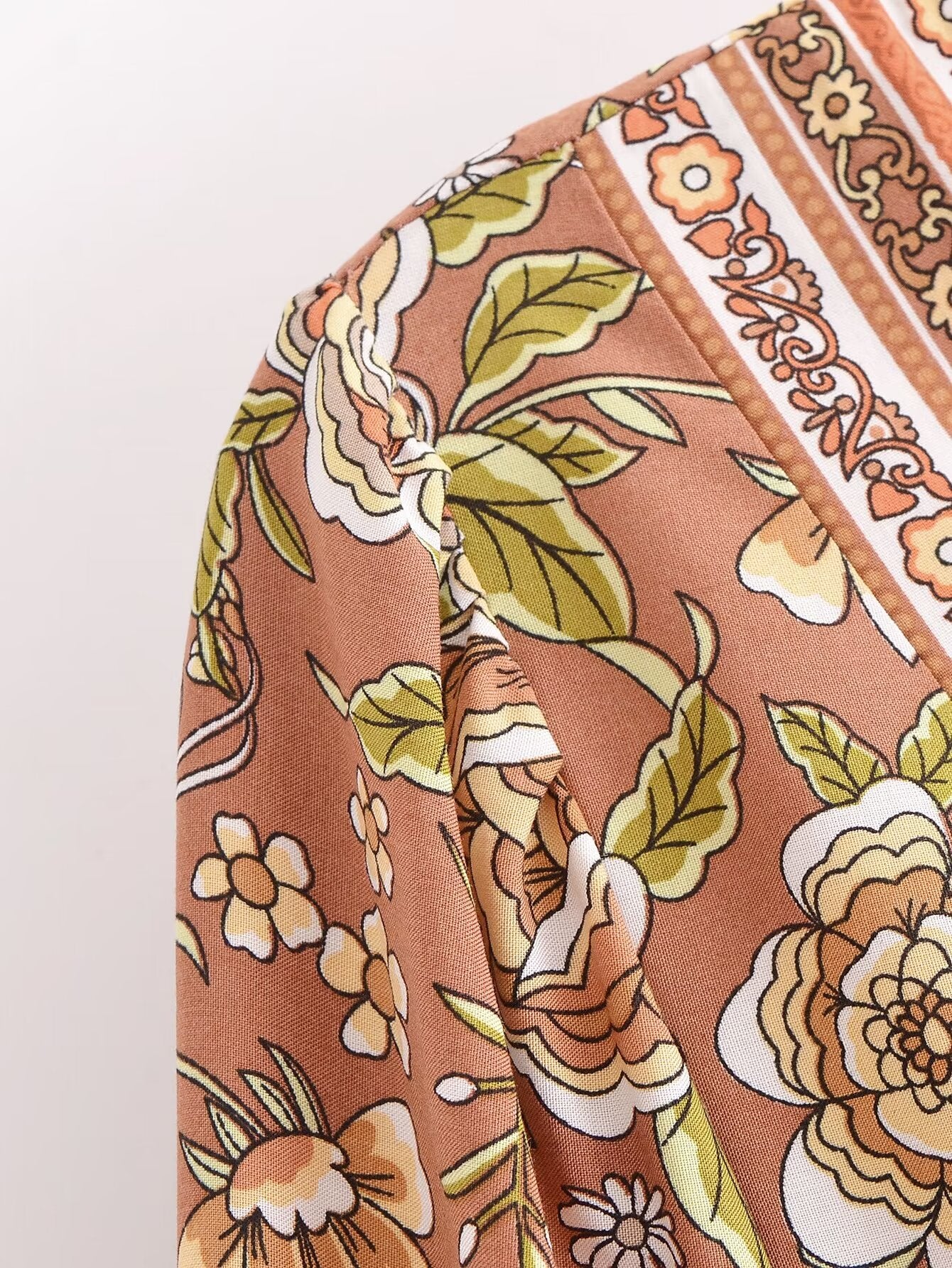 Close-up of Malbusaat rayon printed long sleeve dress with floral patterns in earthy tones