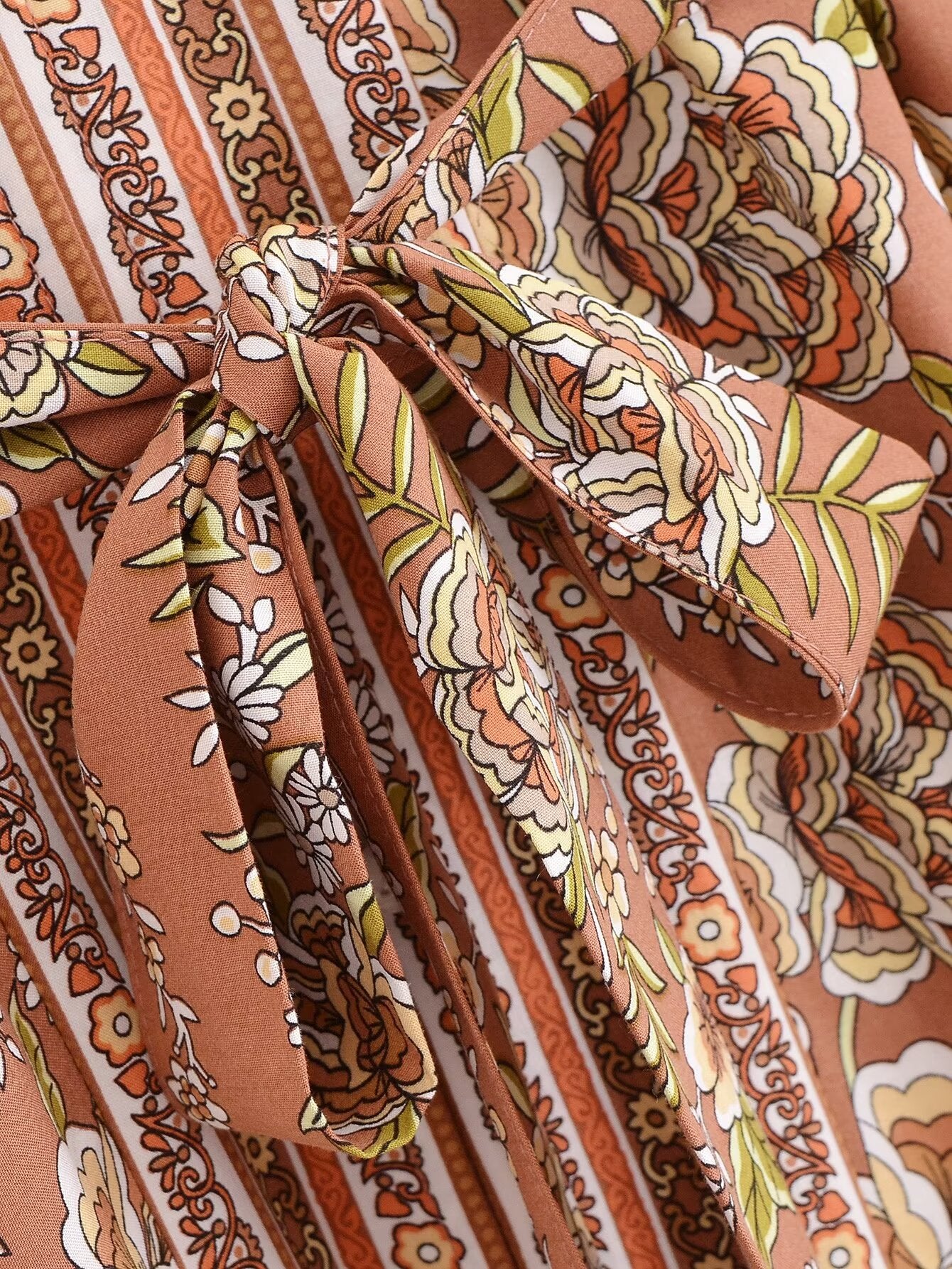 Close-up of Malbusaat rayon printed long sleeve dress featuring floral and striped print with tied bow detail