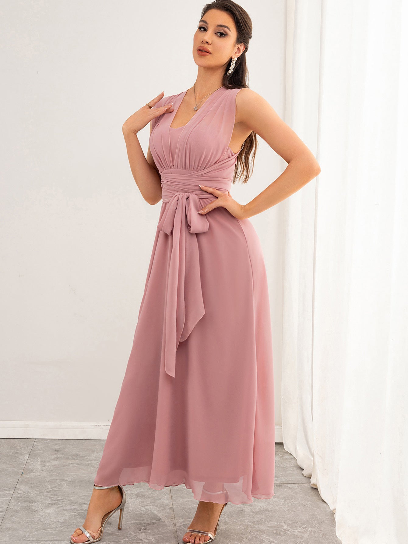 Model wearing Malbusaat chiffon pink maxi dress UK with V neck ruched waist tie sash floor length elegant evening