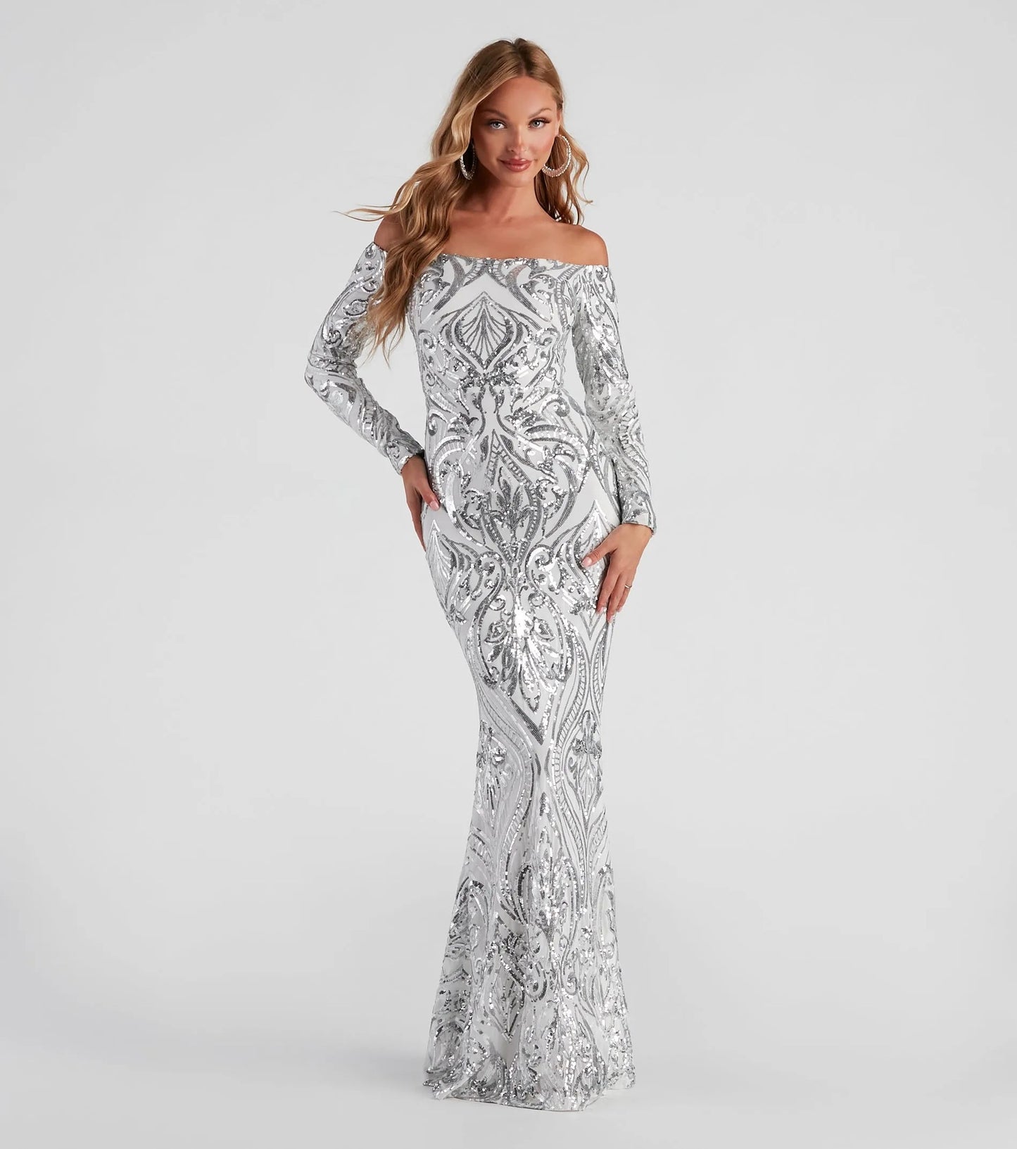 Elegant sequin off shoulder maxi dress by Malbusaat with a stunning silver design