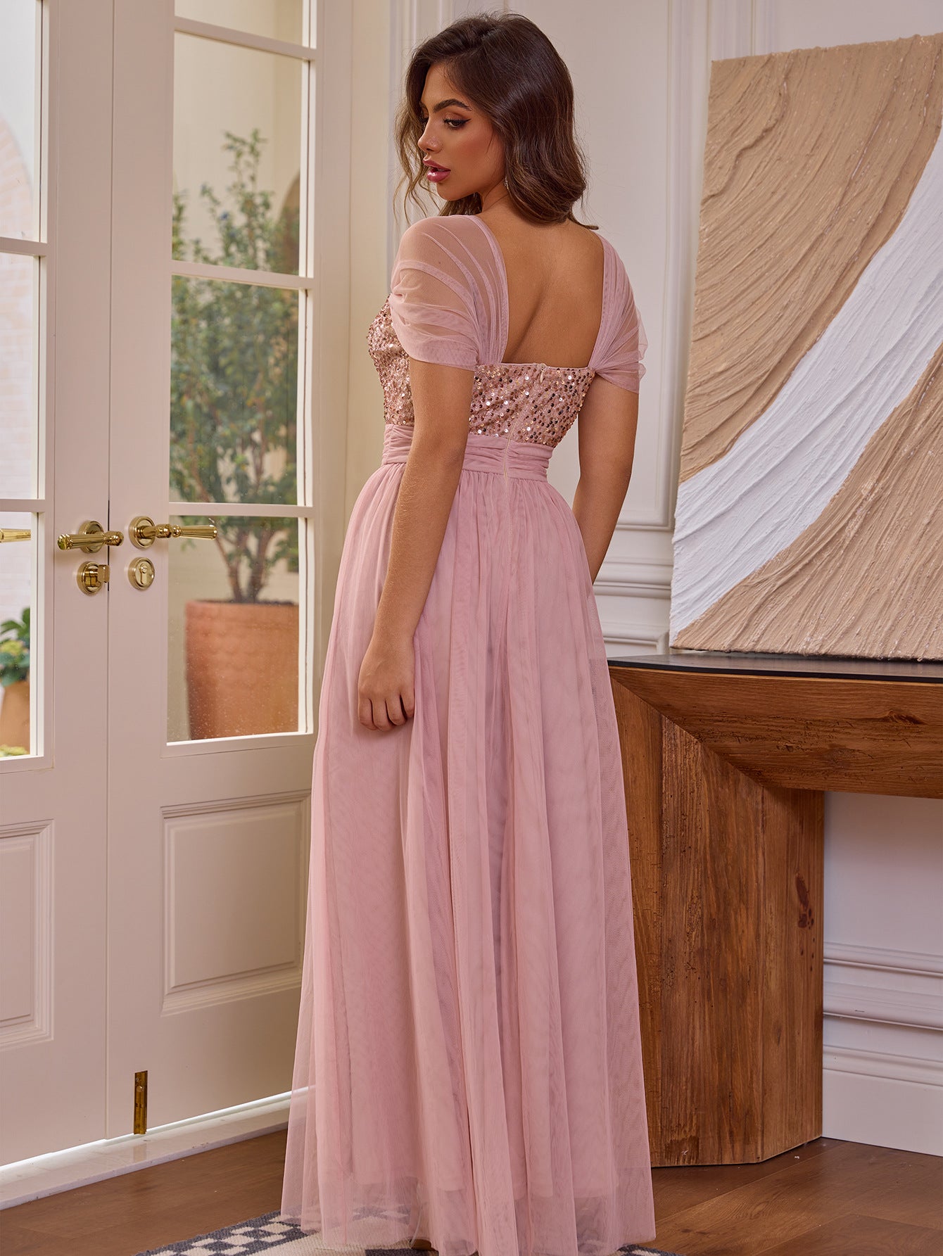 Malbusaat sequined short sleeved dress in soft pink with sheer fabric and elegant floor-length design