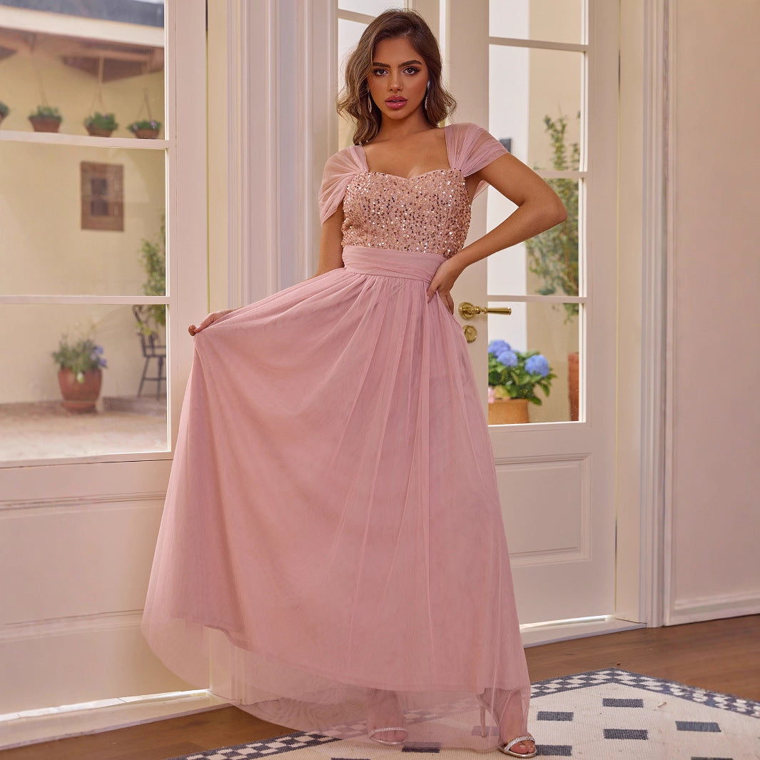 Elegant pink sequined short sleeved dress with flowing tulle skirt by Malbusaat