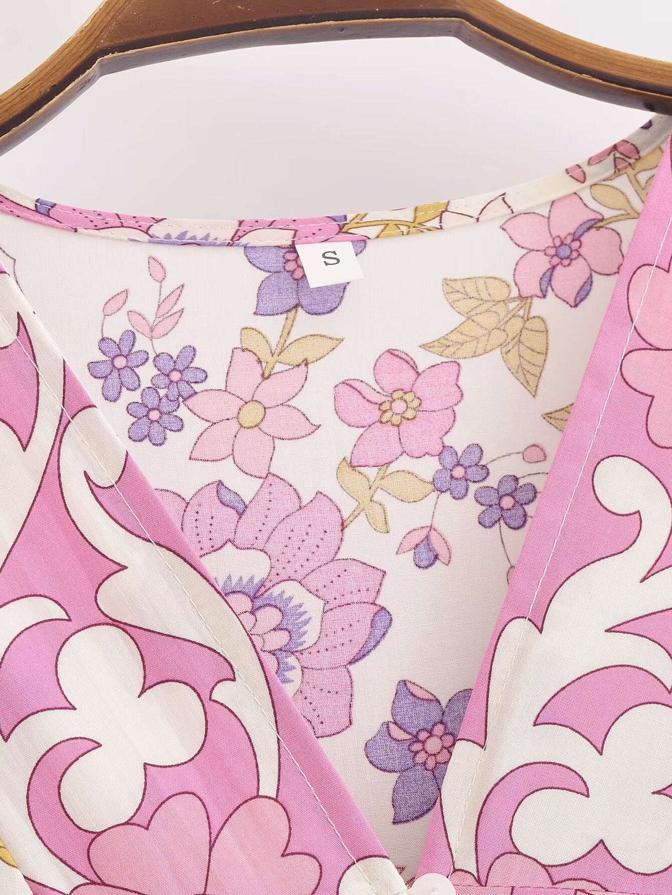 Close-up of Malbusaat spring floral midi dress for women in pink and purple floral pattern on hanger