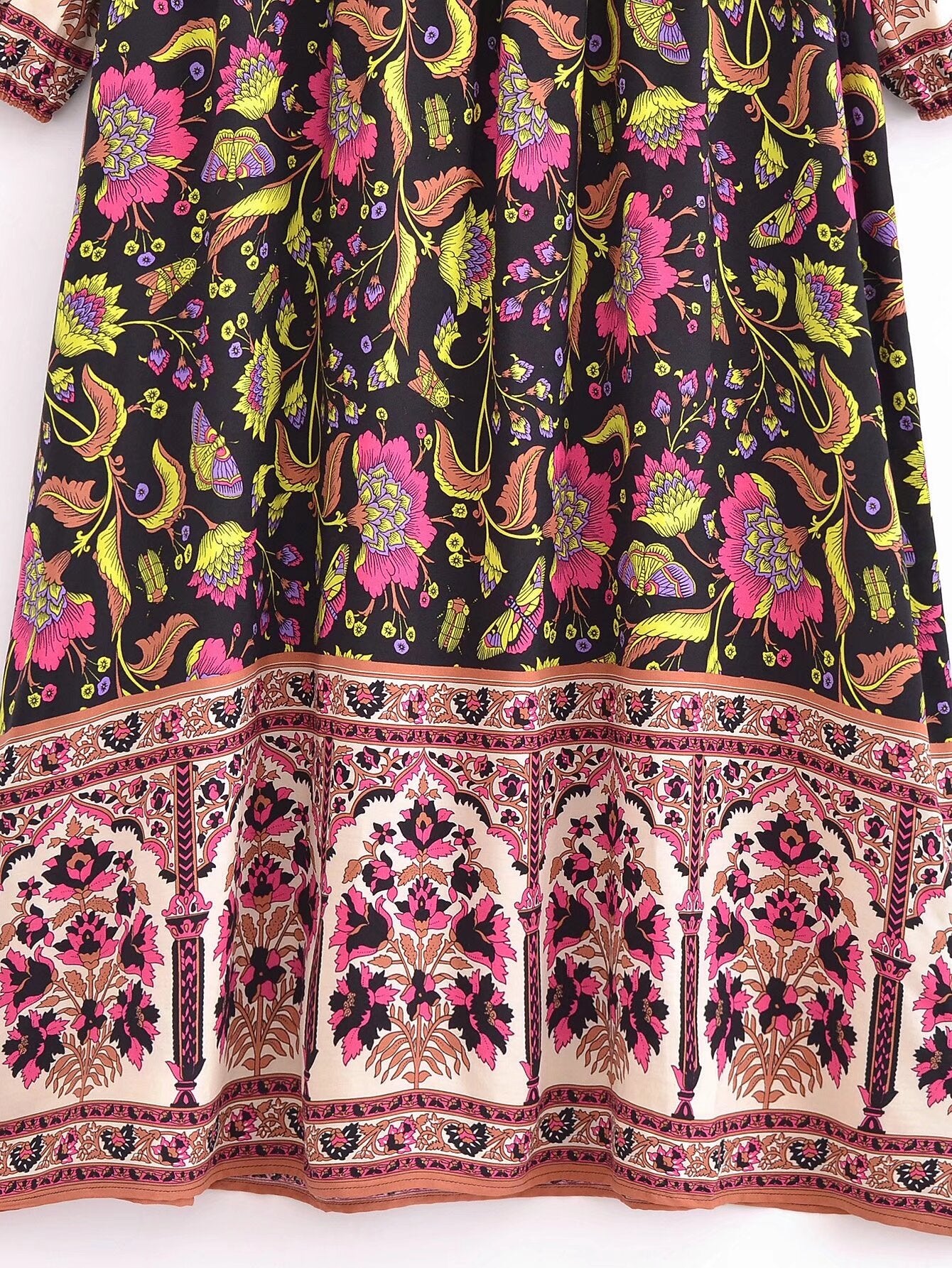 Close-up of Malbusaat spring floral print maxi dress featuring vibrant pink and yellow flowers on a black background