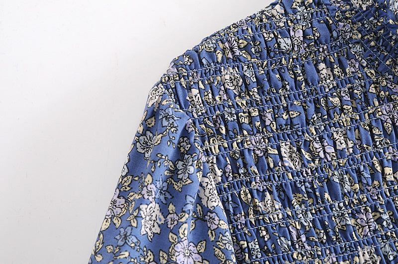 Close-up of blue floral patterned fabric detail on a summer maxi dress for women by Malbusaat