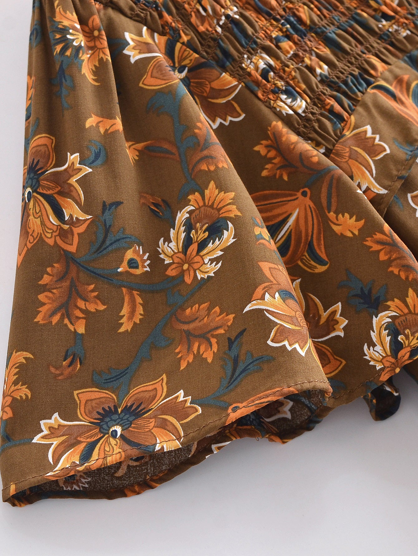 Malbusaat summer printed midi dress close-up of brown floral fabric and smocked detailing