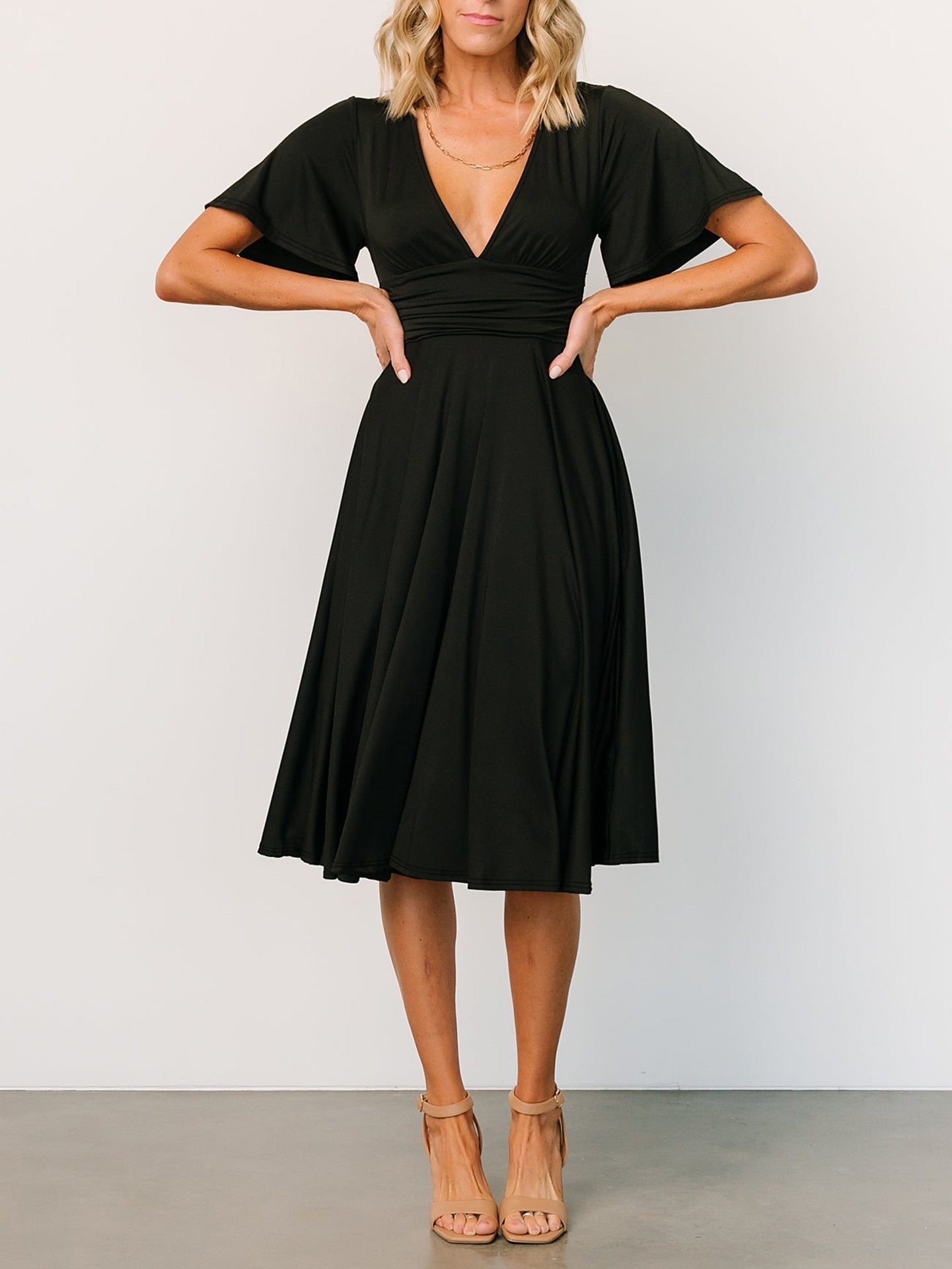 Summer V neck dress for women in black with flutter sleeves and mid-length skirt by Malbusaat