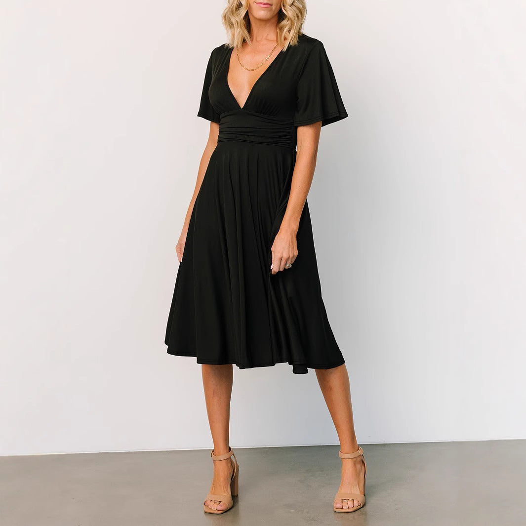 Black summer V neck dress for women with short sleeves and midi length styled with nude heels