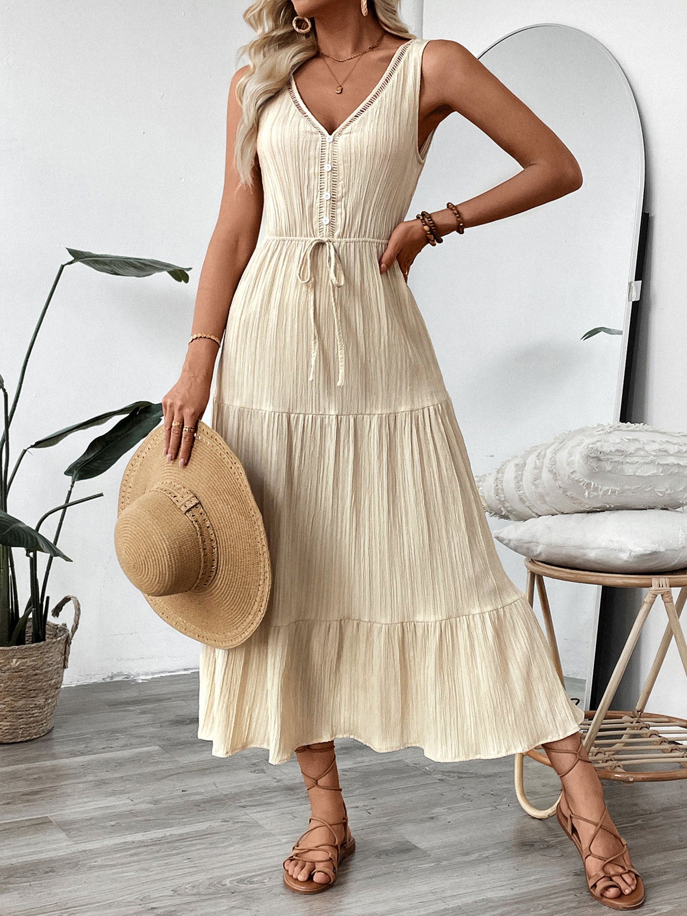 Malbusaat summer V-neck maxi dress in cream with button front and tie waist, styled with straw hat and sandals