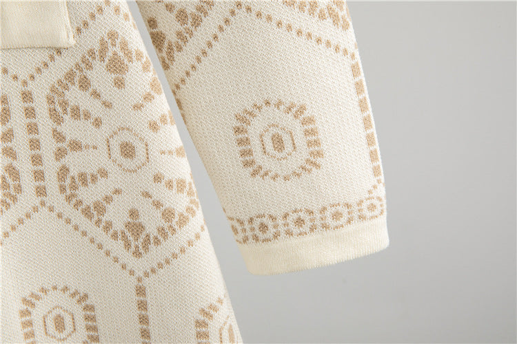 Detail of Malbusaat tassel button knit dress showcasing a patterned design in soft cream and beige tones
