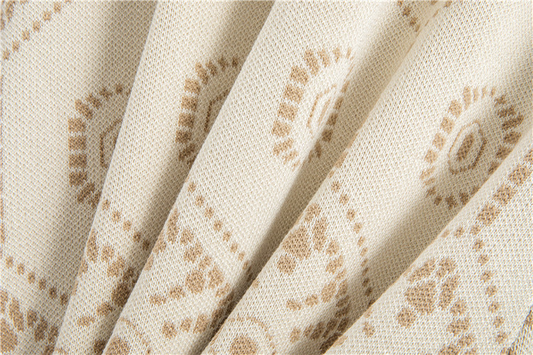 Close-up of fabric pattern showcasing the soft texture of a tassel button knit dress