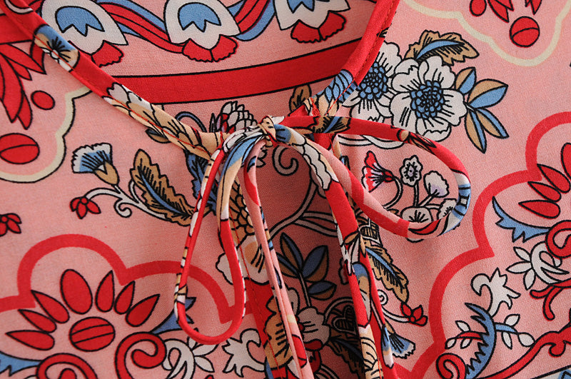 Close-up of colourful floral print and tied neckline on long sleeve floral dress for women by Malbusaat