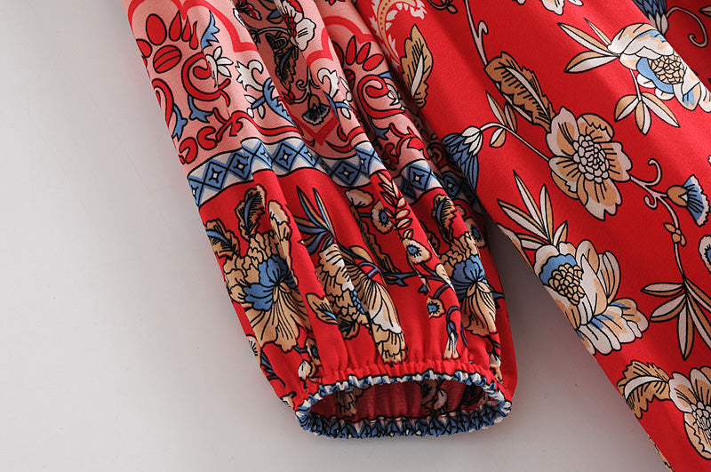 Close-up of Malbusaat long sleeve floral dress for women showing detailed red floral patterned fabric and sleeve cuff