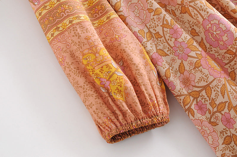 Close-up of long sleeve rayon tassel dress with floral patterns and elastic cuff by Malbusaat