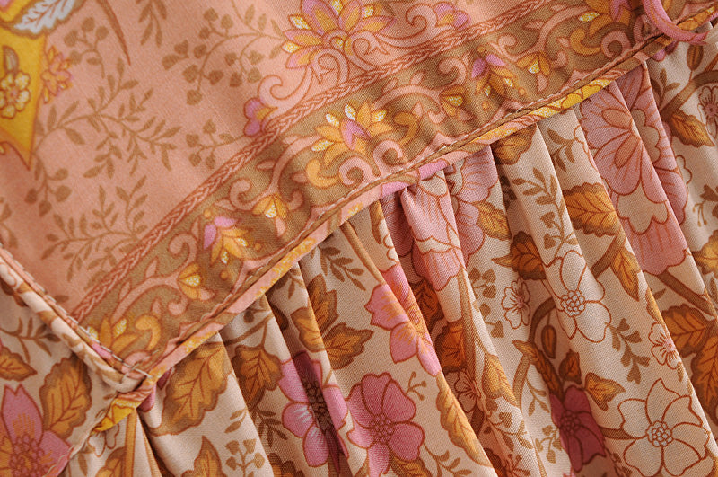 Close-up detail of floral pattern and fabric texture on Malbusaat long sleeve rayon tassel dress